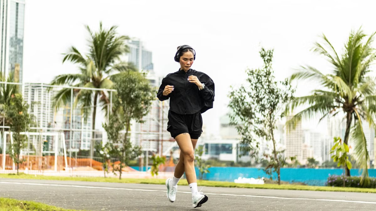 A woman enjoying a morning run in a vibrant park in Panama City, Panama.